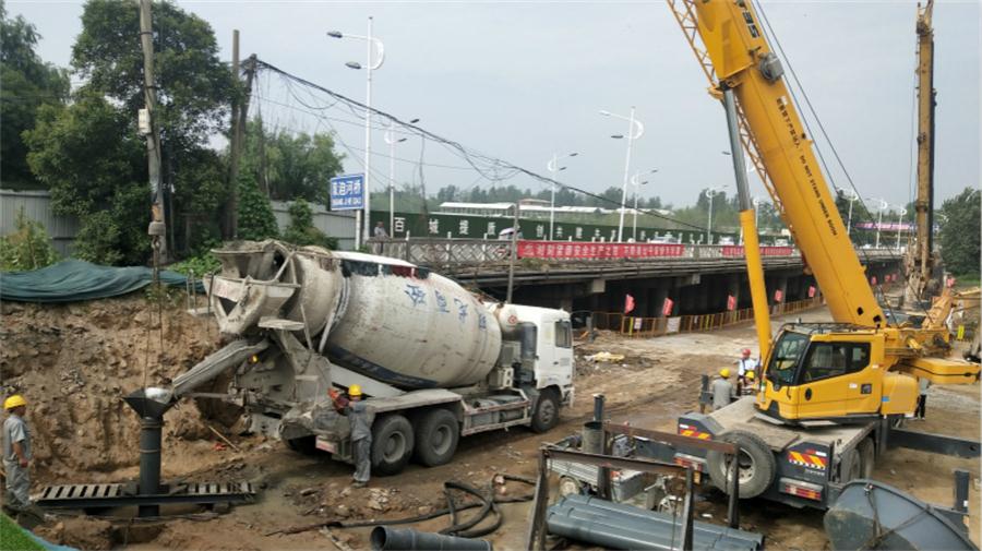 早晨7时许,经过一夜的施工工序准备,混凝土搅拌车开始灌注混凝土,桩基