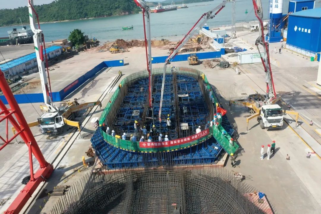 混凝土搅拌运输车、徐工泵车浇筑现场 - 防城港企沙港区赤沙作业区1号泊位工程首个椭圆沉箱底座砼浇筑完成